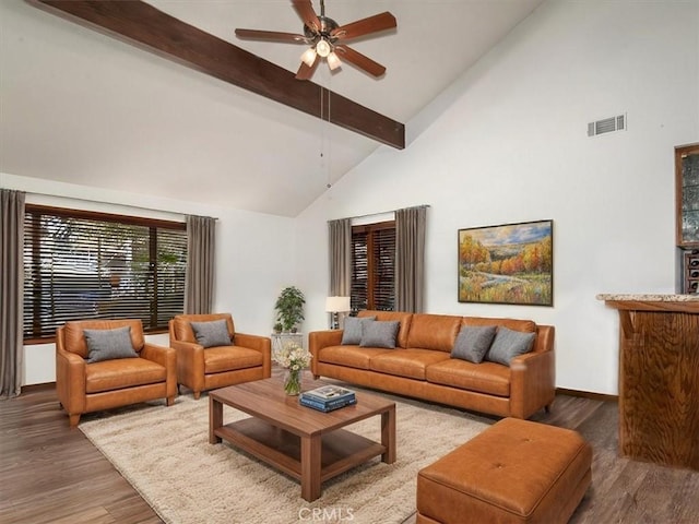 living room featuring dark hardwood / wood-style flooring, beamed ceiling, high vaulted ceiling, and ceiling fan