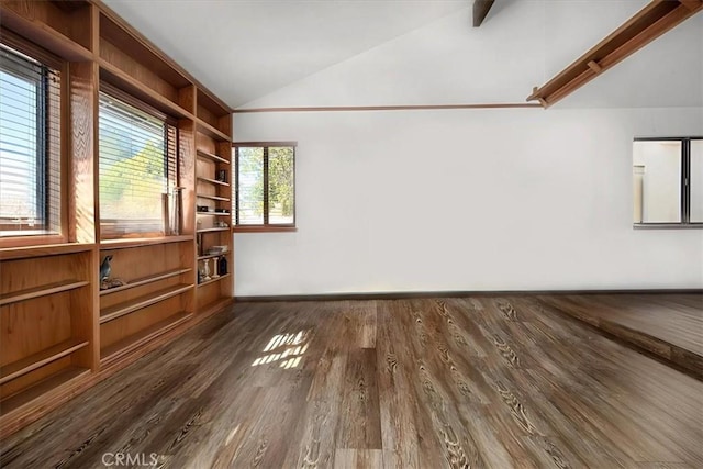 empty room with vaulted ceiling, dark hardwood / wood-style flooring, and built in shelves