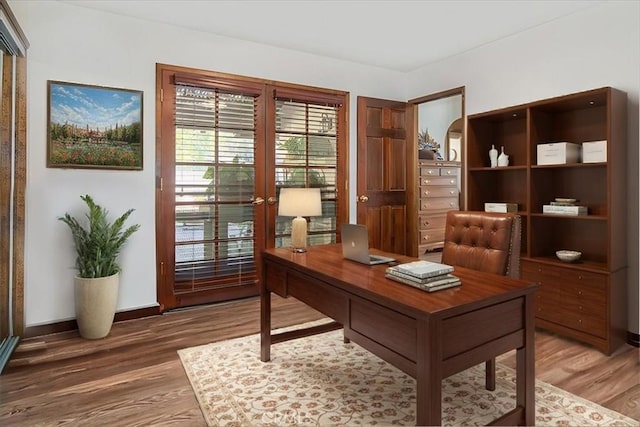 home office with french doors and wood-type flooring