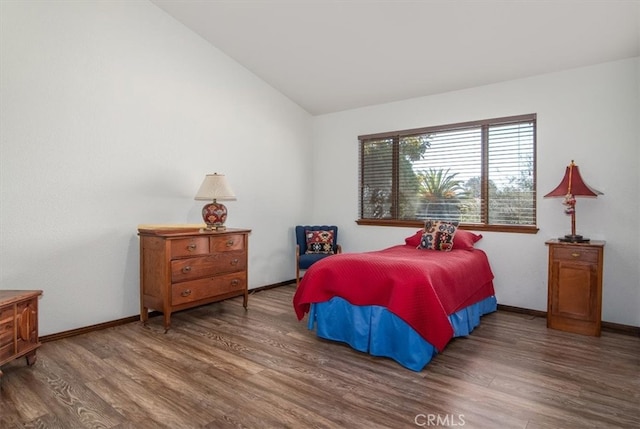 bedroom featuring dark hardwood / wood-style flooring and vaulted ceiling