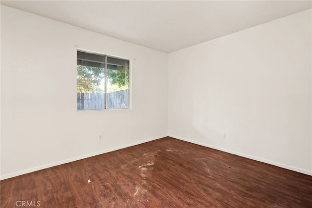 unfurnished room with wood-type flooring