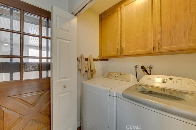 laundry room featuring cabinets and washing machine and clothes dryer