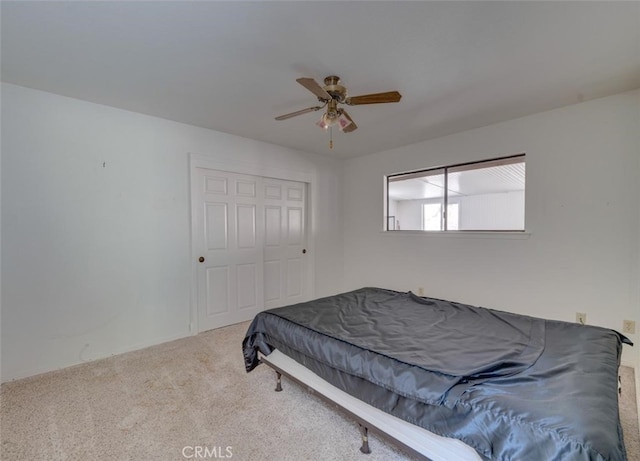 bedroom featuring a closet, carpet, and ceiling fan