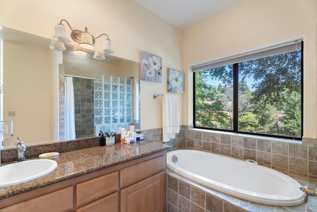 bathroom featuring shower with separate bathtub and vanity