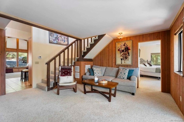 carpeted living room with wooden walls and plenty of natural light