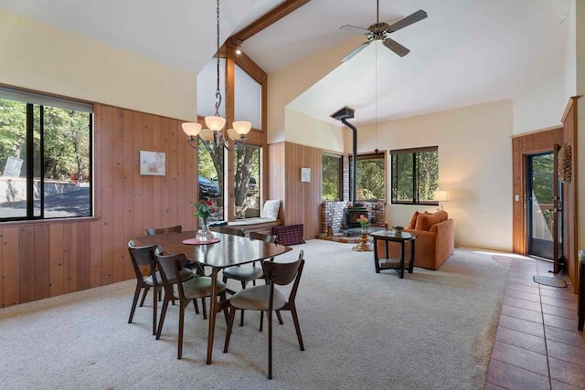 dining space with beam ceiling, high vaulted ceiling, and a wealth of natural light