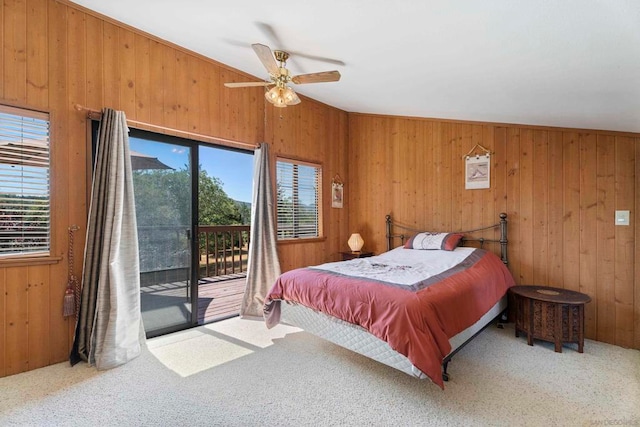 bedroom with carpet flooring, wood walls, ceiling fan, and access to outside