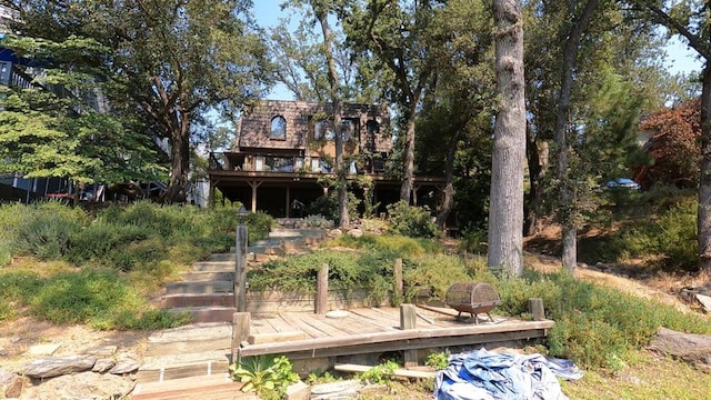 rear view of property with a wooden deck