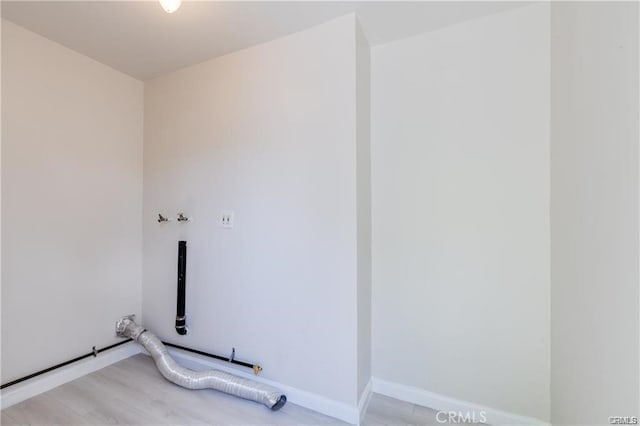 washroom featuring hookup for a washing machine, light wood-style flooring, electric dryer hookup, laundry area, and baseboards