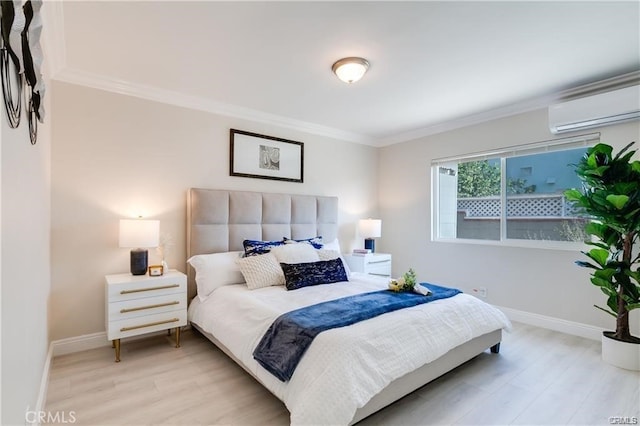 bedroom with baseboards, a wall mounted air conditioner, crown molding, and light wood finished floors