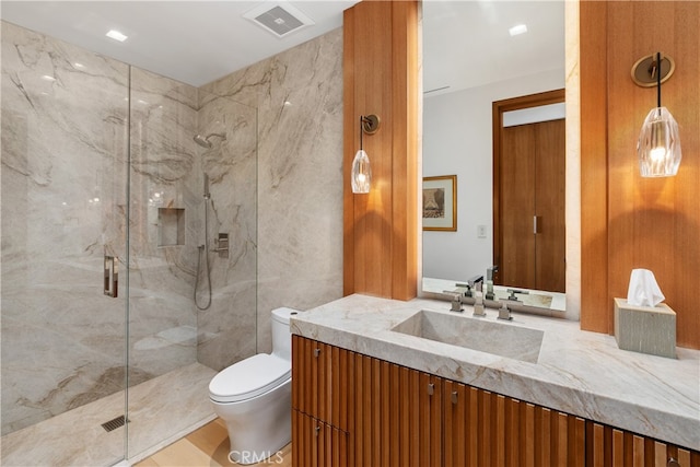 full bathroom featuring a marble finish shower, visible vents, and toilet