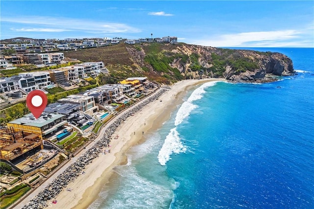 aerial view with a water view and a beach view