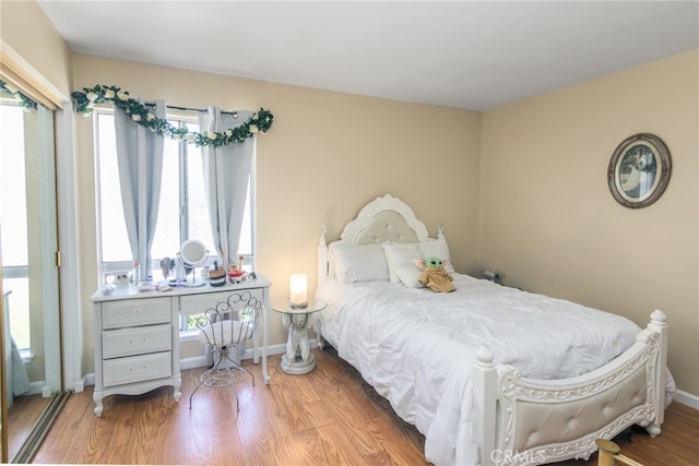 bedroom with hardwood / wood-style flooring