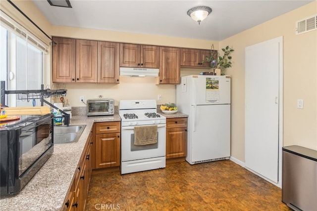 kitchen featuring white appliances and sink