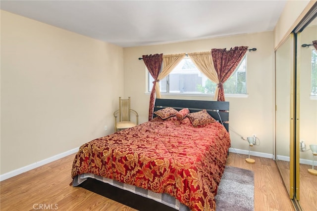 bedroom with a closet and hardwood / wood-style flooring