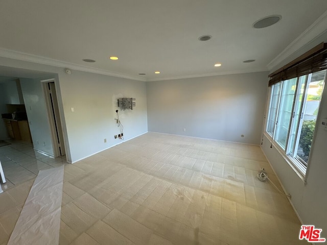 empty room featuring crown molding