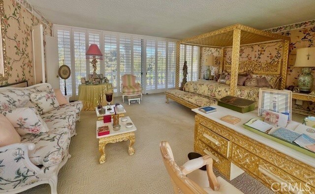 730 Santiago Ave, Long Beach, CA 90804 - living area featuring carpet flooring, healthy amount of natural light, and a textured ceiling