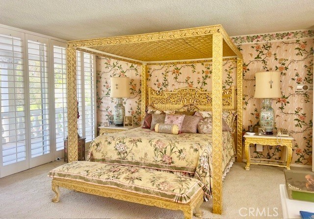 730 Santiago Ave, Long Beach, CA 90804 - bedroom with wallpapered walls, carpet flooring, access to outside, and a textured ceiling