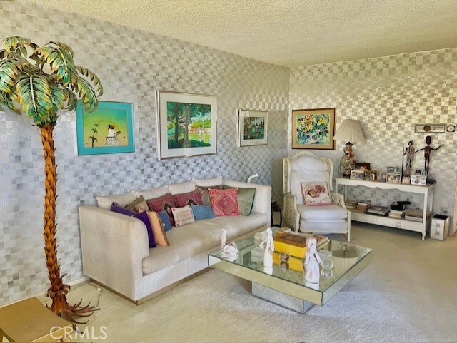 730 Santiago Ave, Long Beach, CA 90804 - carpeted living area featuring a textured ceiling