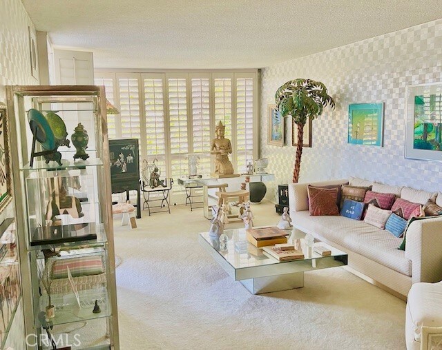 730 Santiago Ave, Long Beach, CA 90804 - living area featuring carpet flooring, wallpapered walls, and a textured ceiling