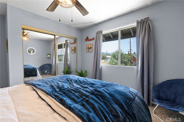 carpeted bedroom featuring a closet and ceiling fan