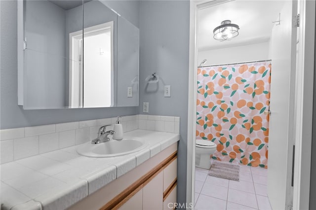 bathroom with vanity, a shower with curtain, toilet, and tile patterned floors