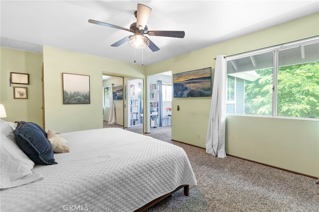 carpeted bedroom with a closet and ceiling fan