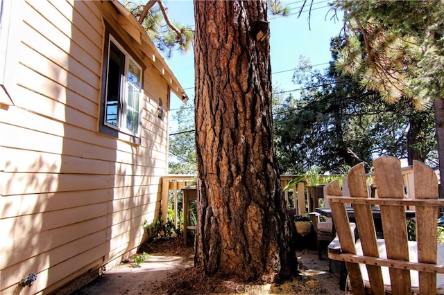 view of side of property featuring fence