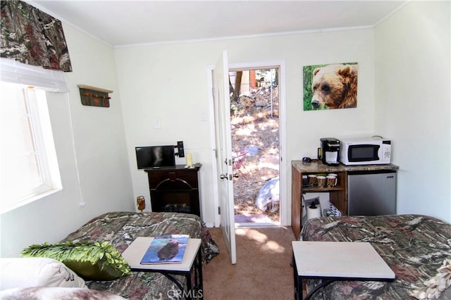 bedroom featuring carpet floors, stainless steel refrigerator, and crown molding