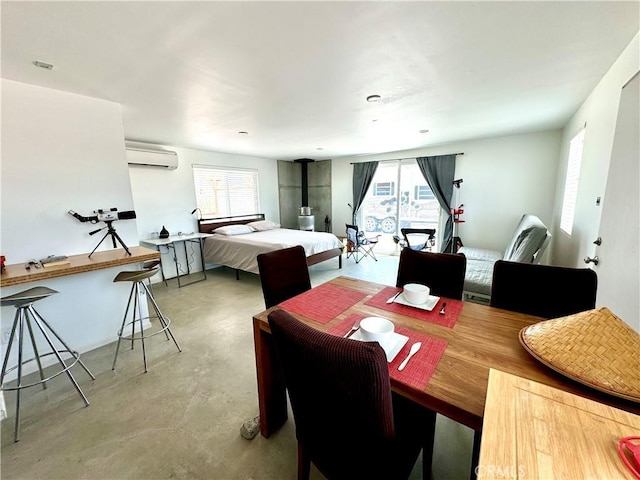 dining area with a wall unit AC and a wood stove