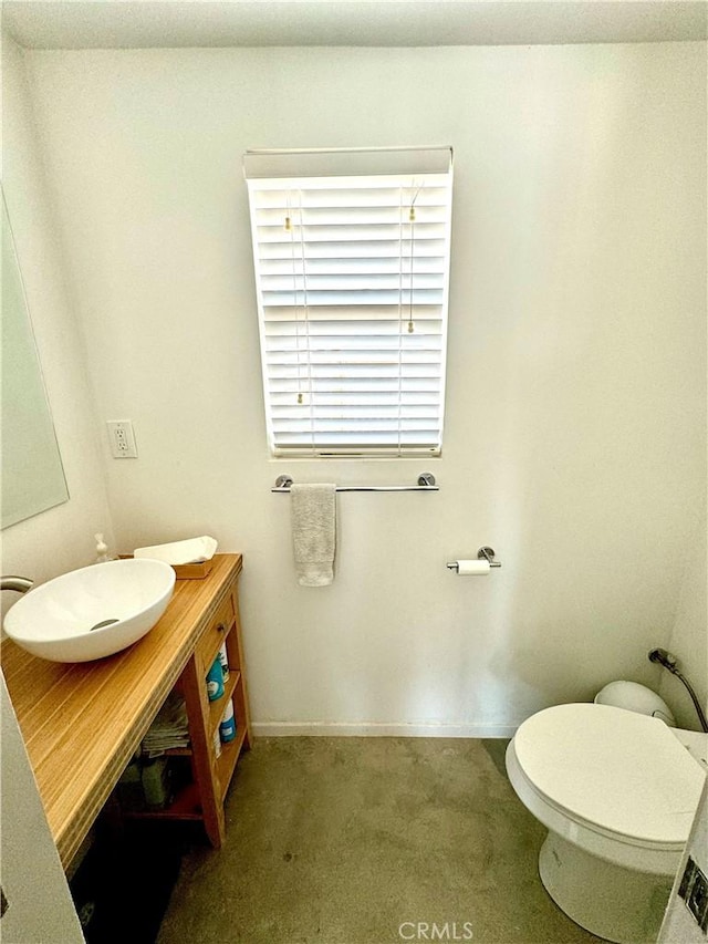 bathroom featuring vanity and toilet