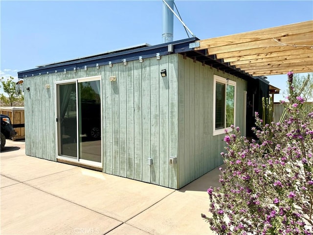 view of home's exterior with a pergola and a patio area