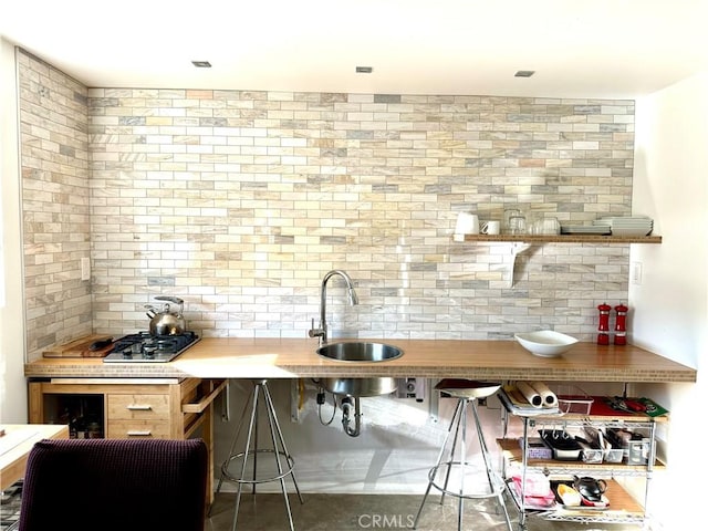 bar featuring tasteful backsplash and sink