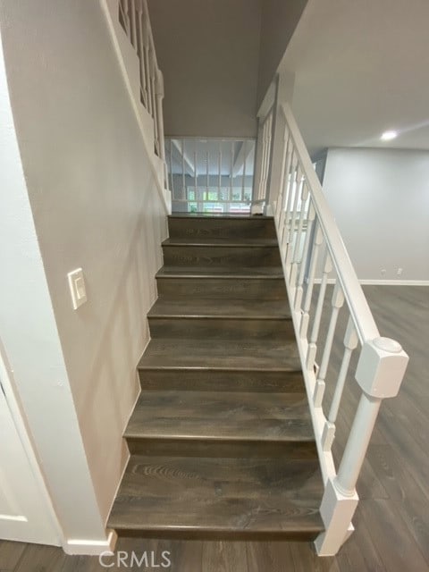 staircase with wood-type flooring