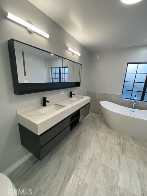 bathroom with a bathing tub and vanity