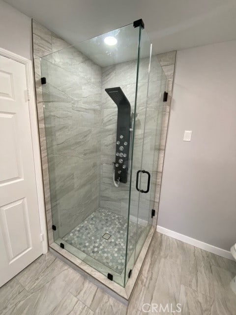 bathroom with a shower with shower door