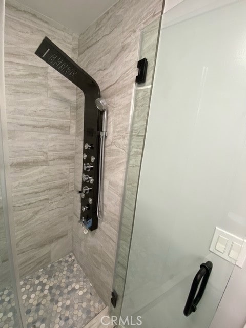 bathroom with a shower with shower door