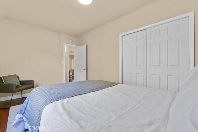 bedroom with a closet and wood finished floors