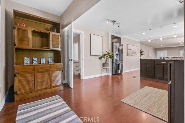 interior space featuring recessed lighting, baseboards, and dark wood finished floors