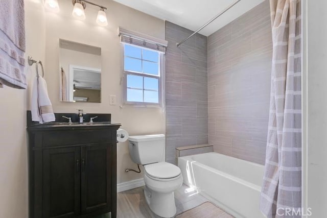 full bath with vanity, toilet, baseboards, and shower / bath combo with shower curtain