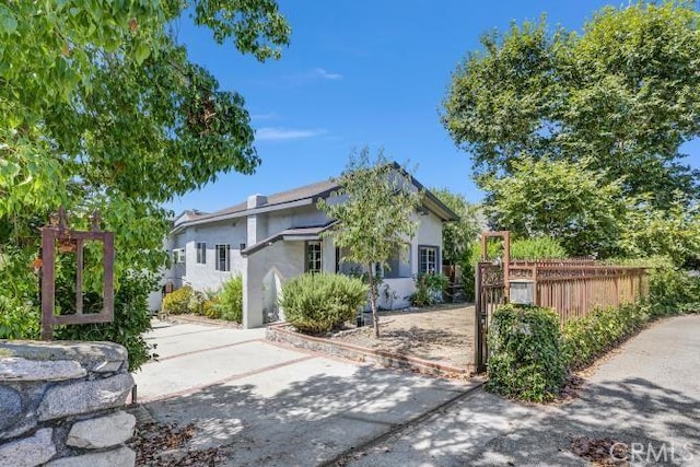 view of front facade featuring fence and stucco siding