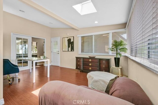 sitting room with recessed lighting, lofted ceiling with skylight, and wood finished floors