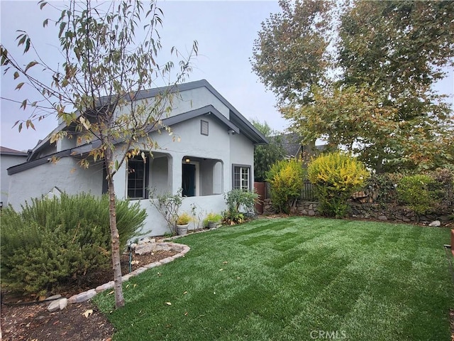 view of side of property with a yard