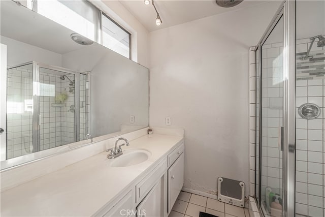 bathroom featuring vanity, heating unit, an enclosed shower, and tile patterned floors