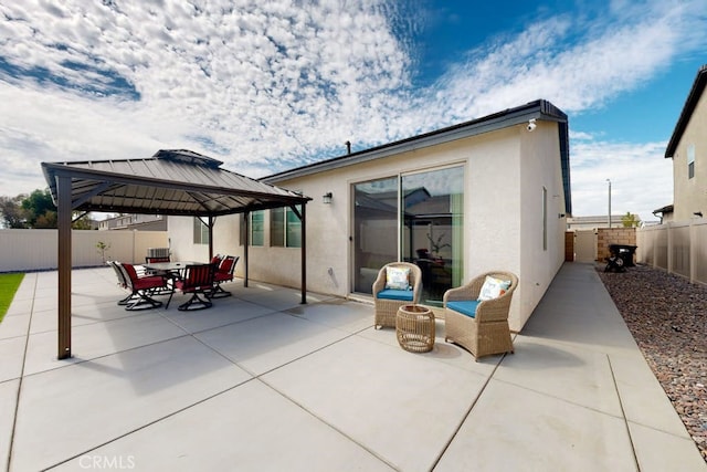 rear view of property with a gazebo and a patio