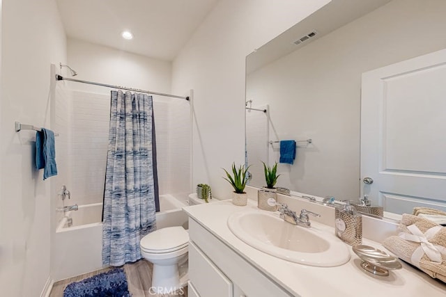 full bathroom featuring hardwood / wood-style floors, vanity, toilet, and shower / bathtub combination with curtain