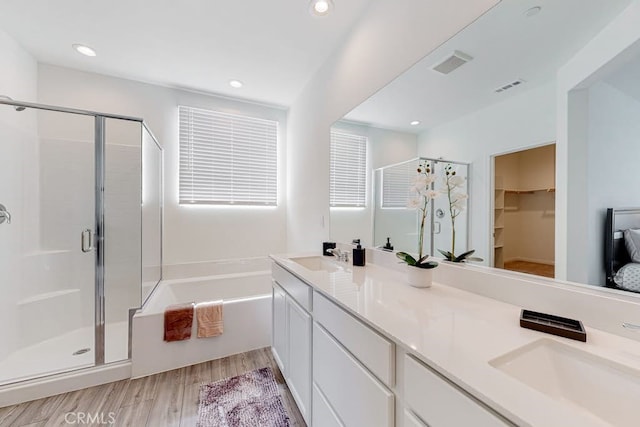 bathroom featuring vanity, hardwood / wood-style flooring, and independent shower and bath