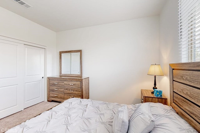 carpeted bedroom featuring a closet