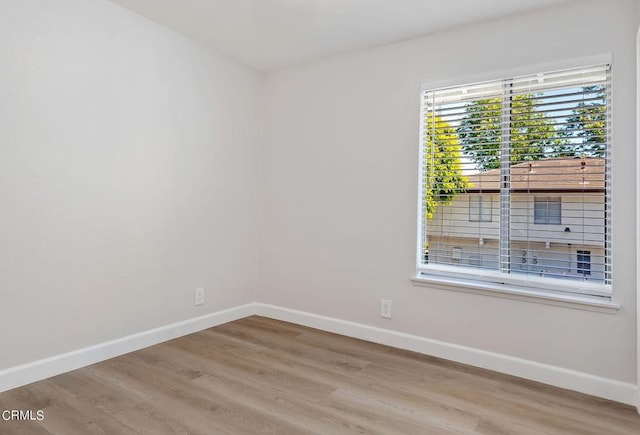 spare room featuring light hardwood / wood-style flooring