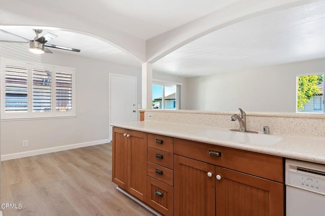 bathroom with ceiling fan, a healthy amount of sunlight, vanity, and hardwood / wood-style floors